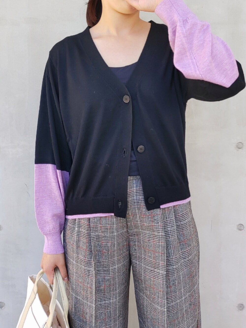 ベージュ系のトートバッグ、ブラック系のスラックス、ブラック系のカーディガン/ボレロを着用したレディースの秋コーディネートの2枚目の写真