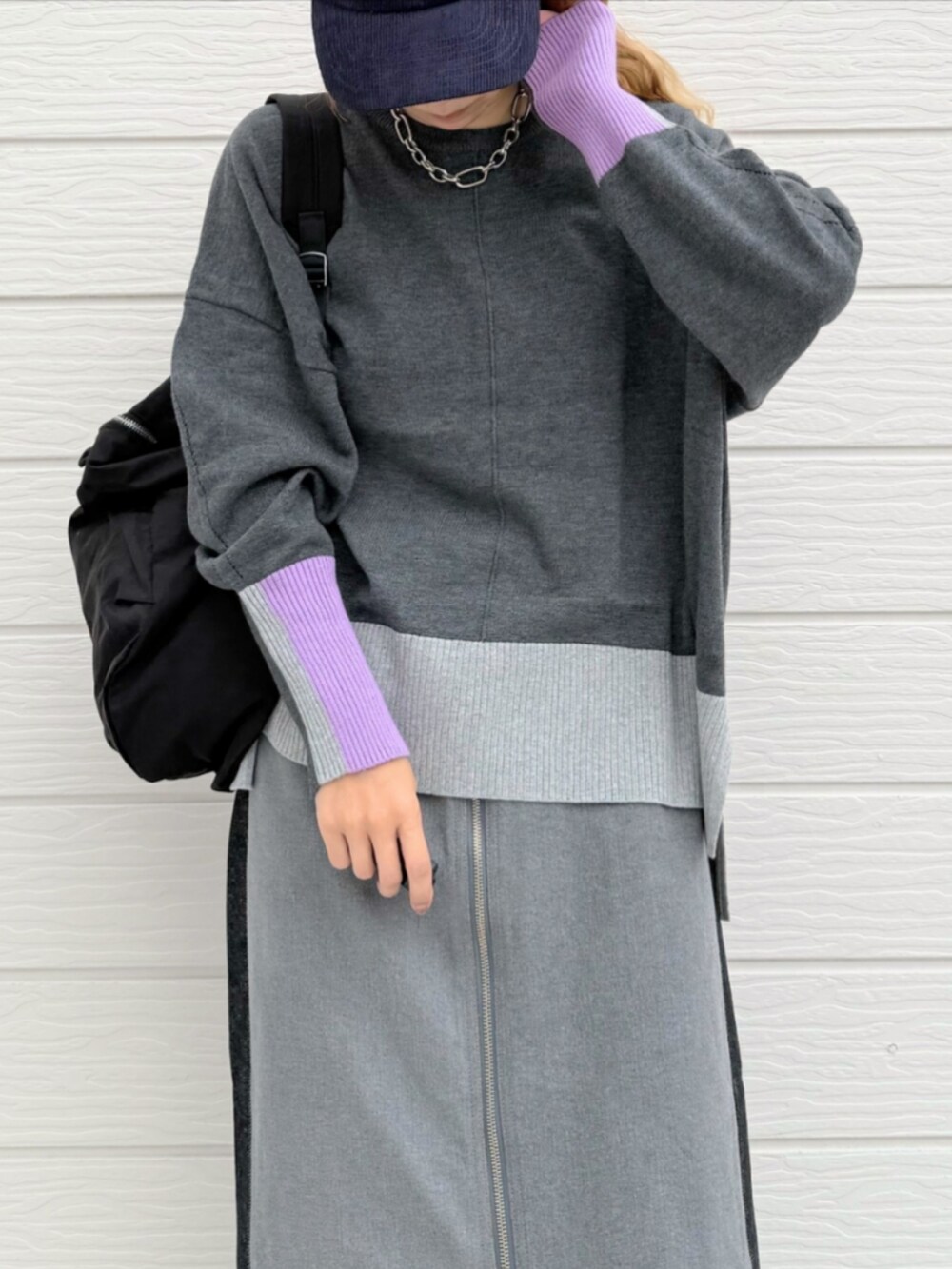 ブラック系のデニムパンツ、グレー系のニット/セーター、ブラック系のバックパック/リュックを着用したレディースの秋コーディネートの4枚目の写真
