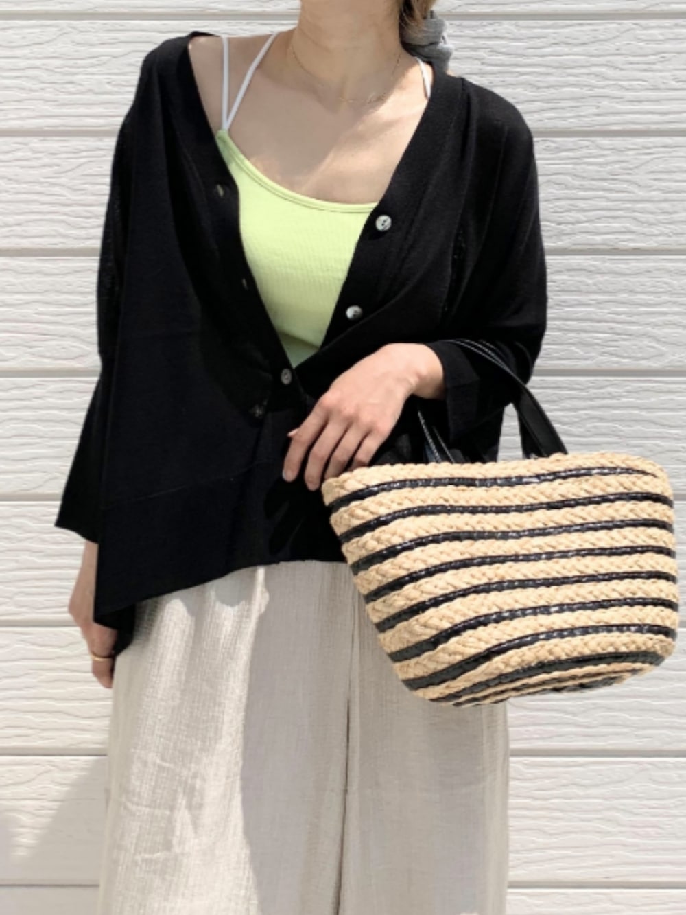 ベージュ系のその他パンツ、ブラック系のかごバッグ、ブラック系のカーディガン/ボレロを着用したレディースの春コーディネートの5枚目の写真