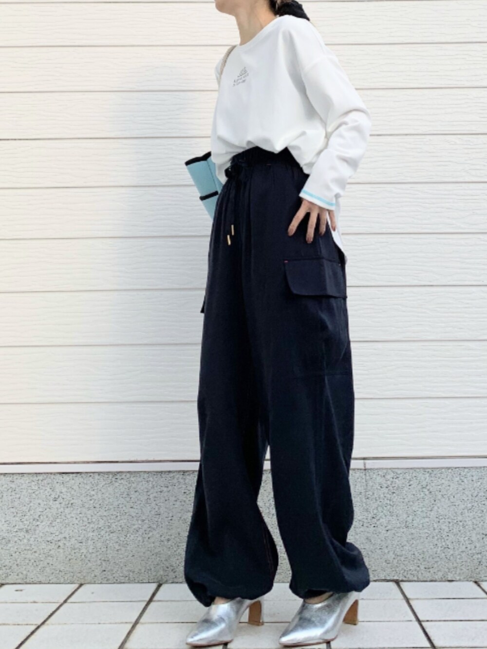 ホワイト系のTシャツ/カットソー、ブルー系のトートバッグ、ブルー系のカーゴパンツを着用したレディースの冬コーディネートの2枚目の写真