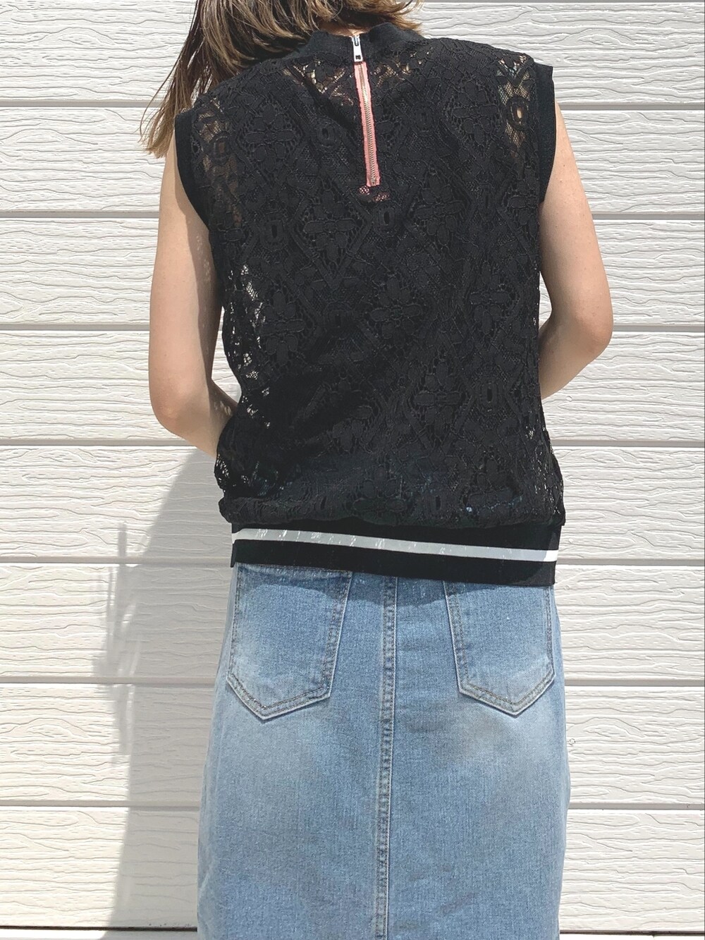 ブルー系のデニムスカート、ブラック系のTシャツ/カットソー、レッド系のショルダーバッグを着用したレディースの夏コーディネートの2枚目の写真
