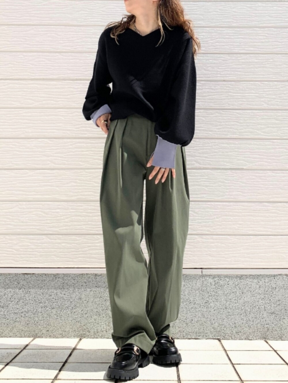 グリーン系のその他パンツ、ブラック系のローファー、ブラック系のニット/セーターを着用したレディースの秋コーディネートの2枚目の写真