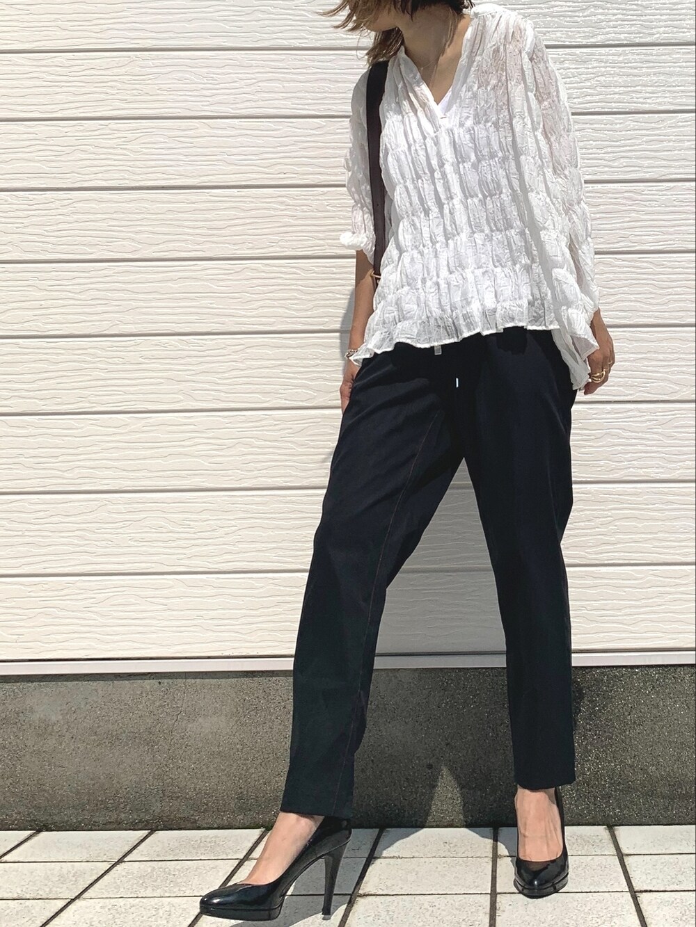 ホワイト系のシャツ/ブラウス、ブラウン系のショルダーバッグ、ブラック系のその他パンツを着用したレディースの夏コーディネートの2枚目の写真