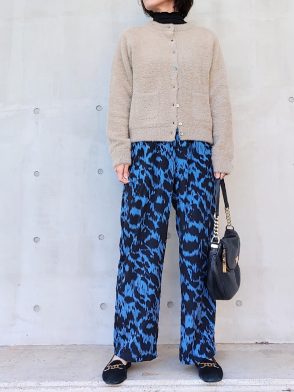 ブルー系のその他パンツ、ブラック系のバッグ、ベージュ系のカーディガン/ボレロを着用したレディースの秋コーディネートの2枚目の写真