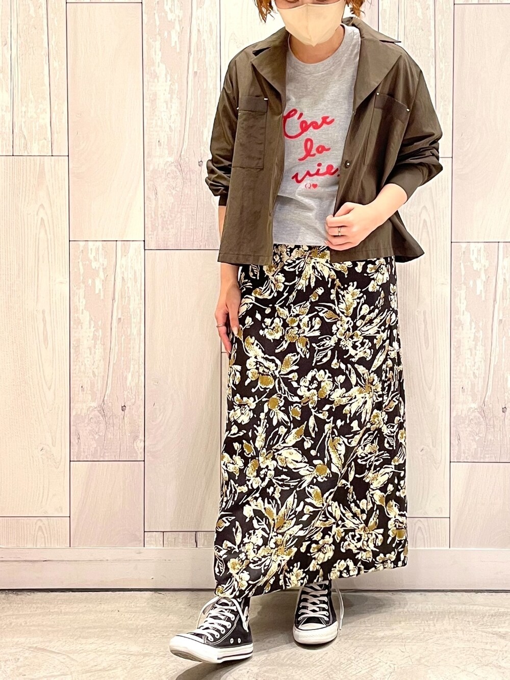 グレー系のTシャツ/カットソー、グリーン系のブルゾン、ブラック系のスカートを着用したレディースの秋コーディネートの2枚目の写真