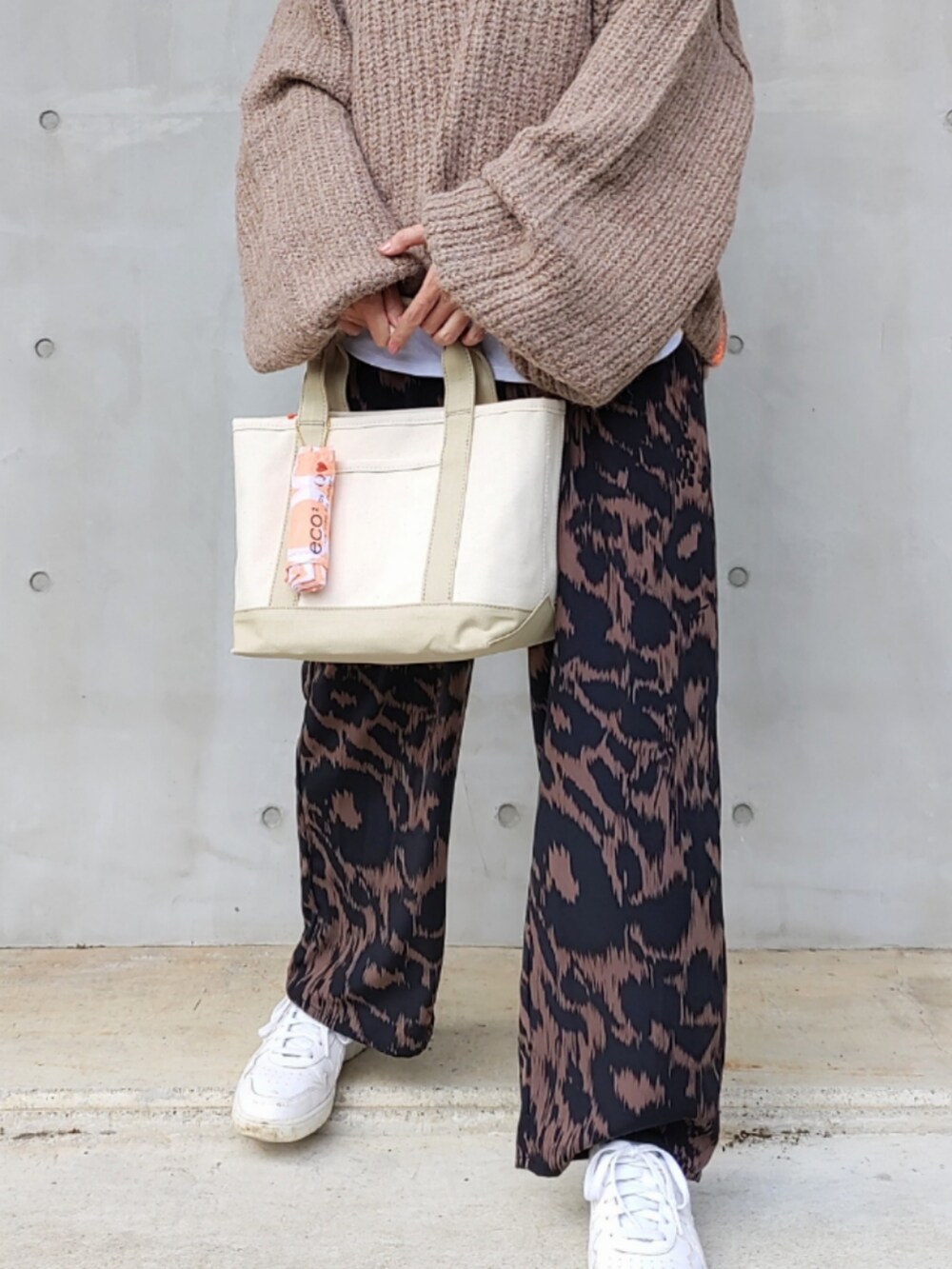 ブラウン系のその他パンツ、ベージュ系のニット/セーター、ベージュ系のトートバッグを着用したレディースの秋コーディネートの4枚目の写真