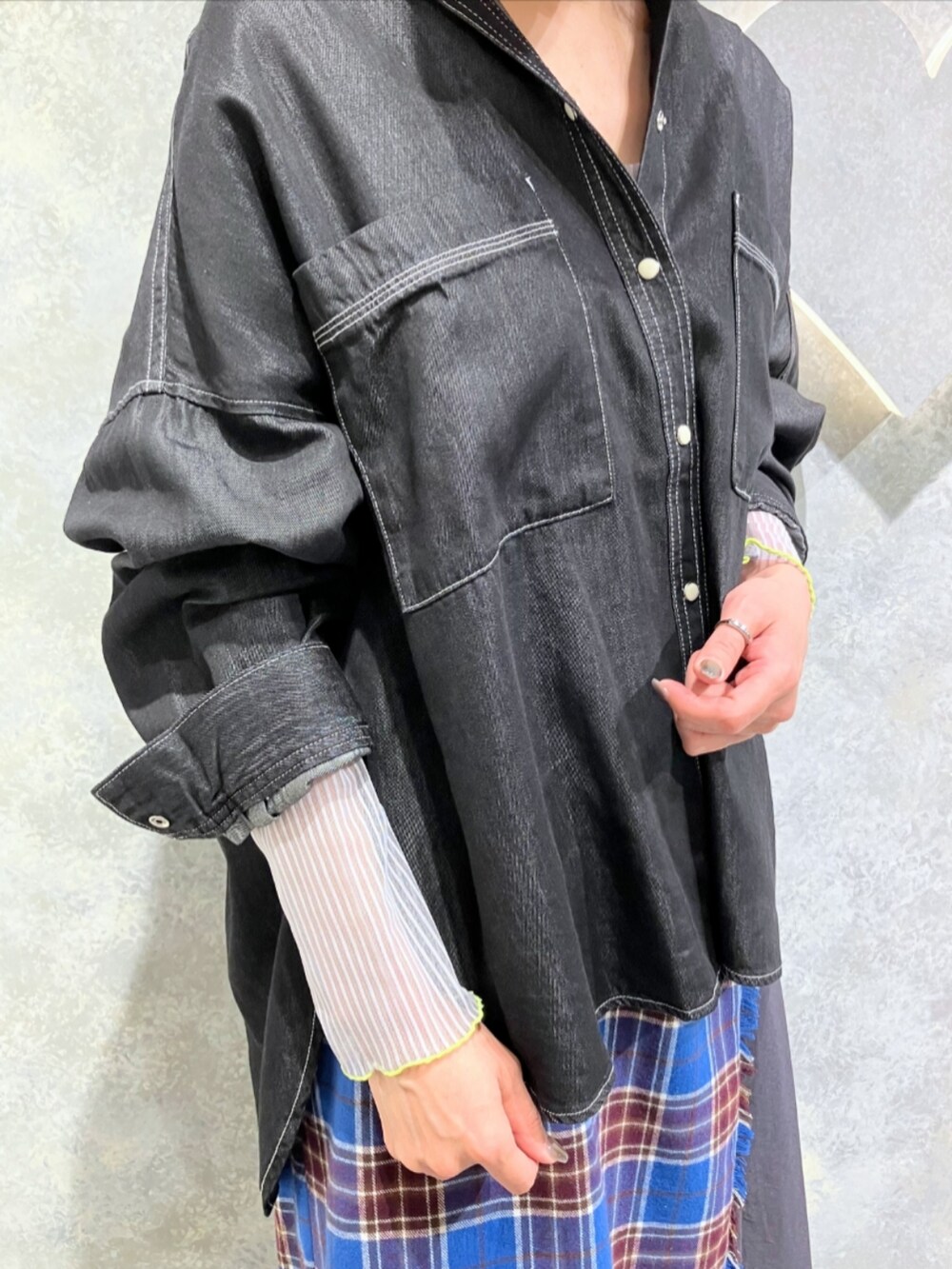 グレー系のブーツ、ブルー系のスカート、グレー系のTシャツ/カットソーを着用したレディースの秋コーディネートの5枚目の写真