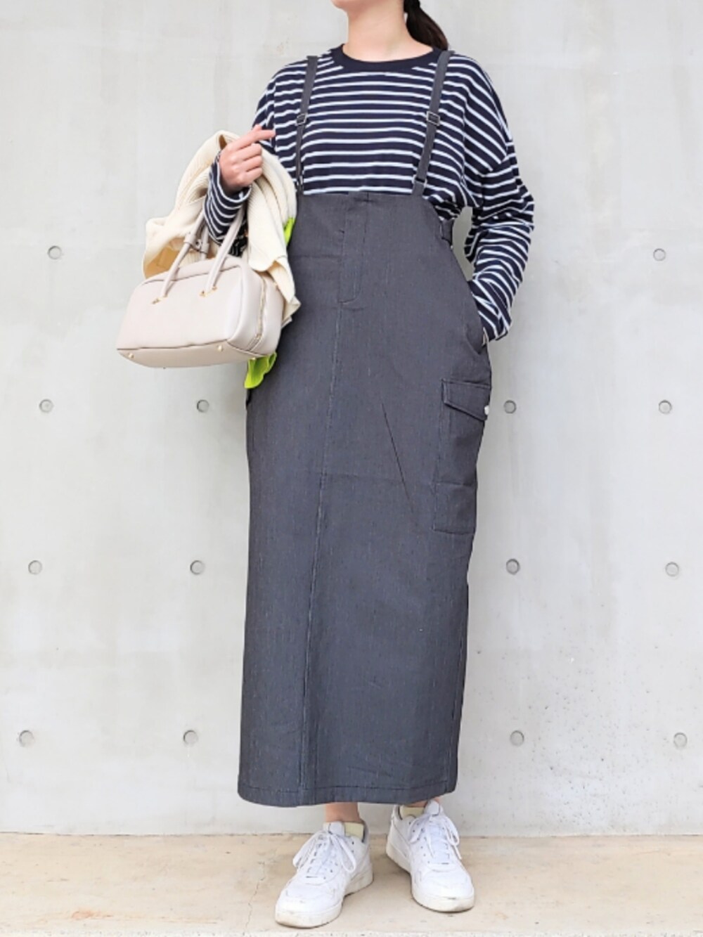 ホワイト系のボストンバッグ、ホワイト系のスニーカー、ホワイト系のカーディガン/ボレロを着用したレディースの冬コーディネートの2枚目の写真