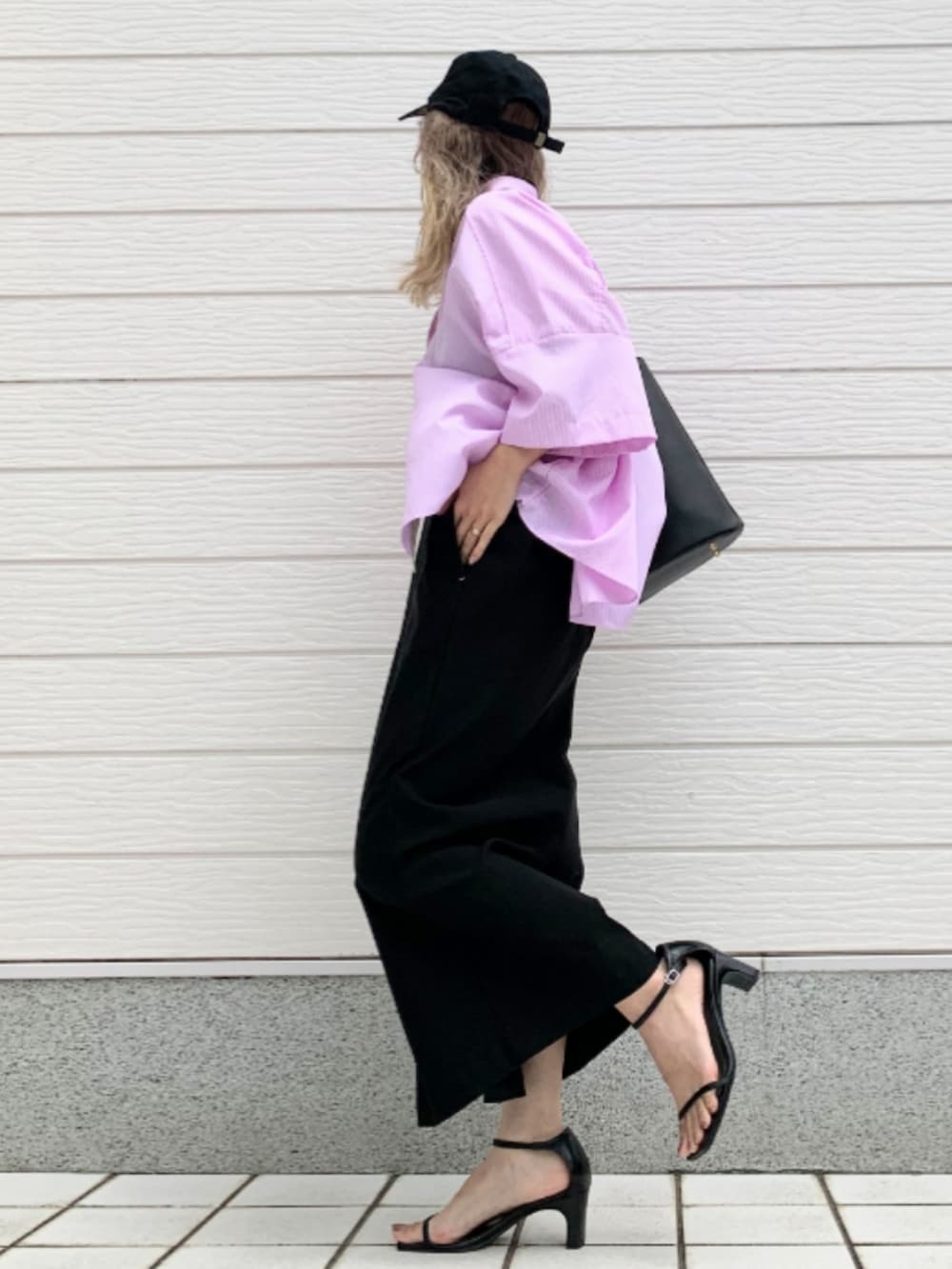 ブラック系のトートバッグ、ブラック系のキャミソール、ブラック系のスカートを着用したレディースの春コーディネートの2枚目の写真