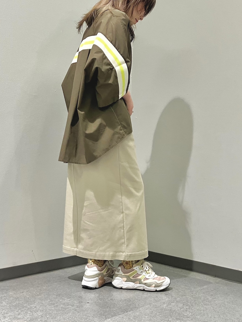 ホワイト系のショルダーバッグ、グリーン系のシャツ/ブラウス、ベージュ系のスカートを着用したレディースの春コーディネートの4枚目の写真