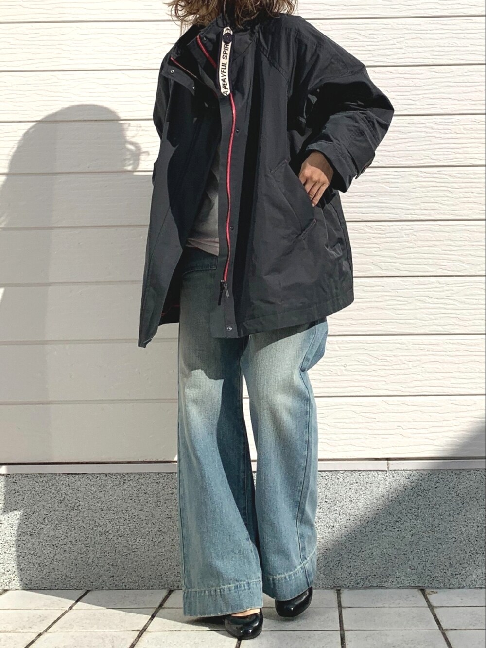 ブルー系のデニムパンツ、グレー系のその他アウター、ホワイト系のニット/セーターを着用したレディースの冬コーディネートの2枚目の写真