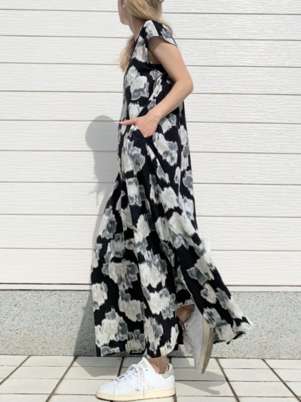 ブラック系のワンピース、ホワイト系のスニーカー、ホワイト系のトートバッグを着用したレディースの春コーディネートの2枚目の写真