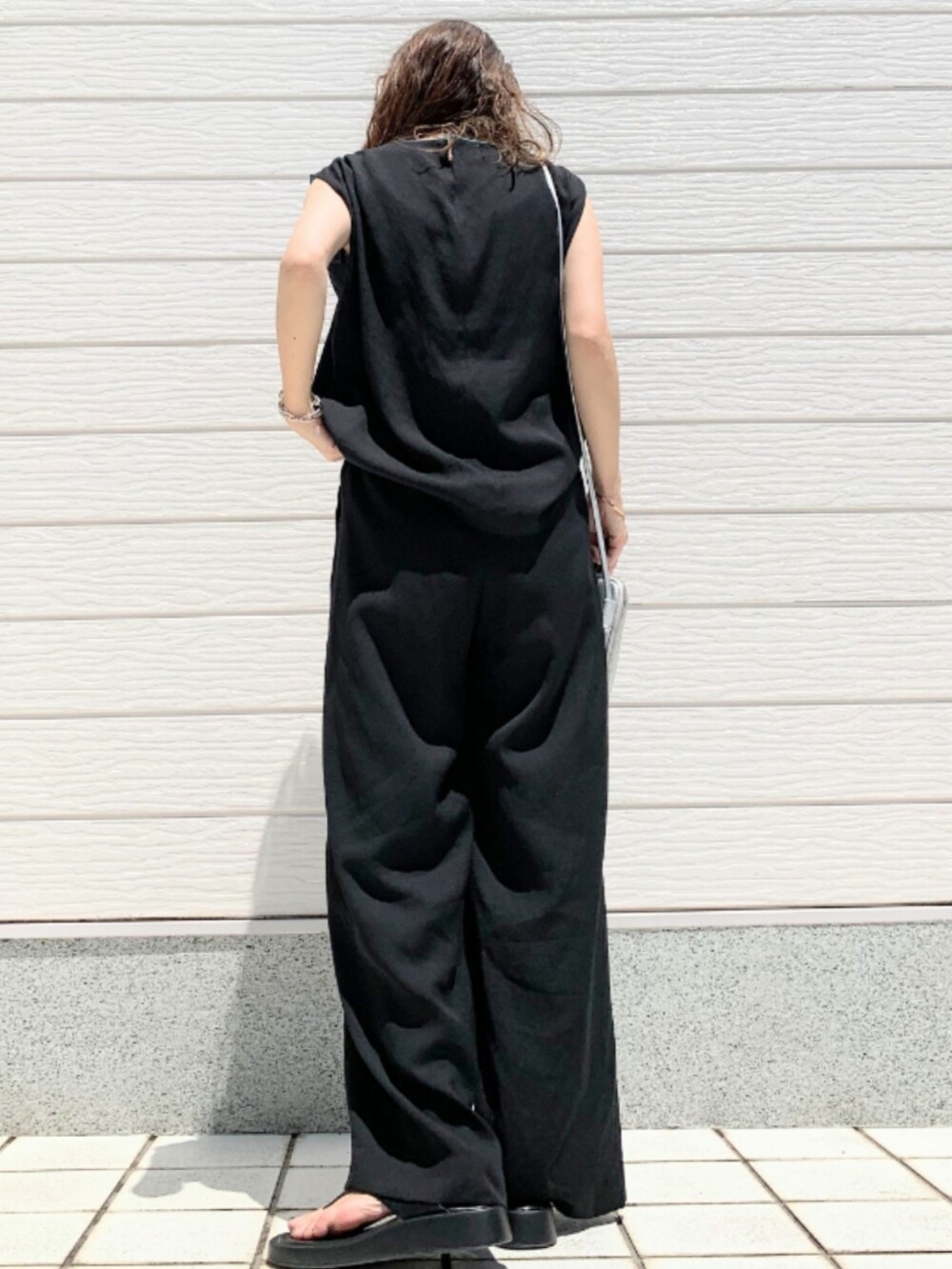 ブラック系のその他パンツ、ブラック系のシャツ/ブラウス、シルバー系のショルダーバッグを着用したレディースの夏コーディネートの3枚目の写真