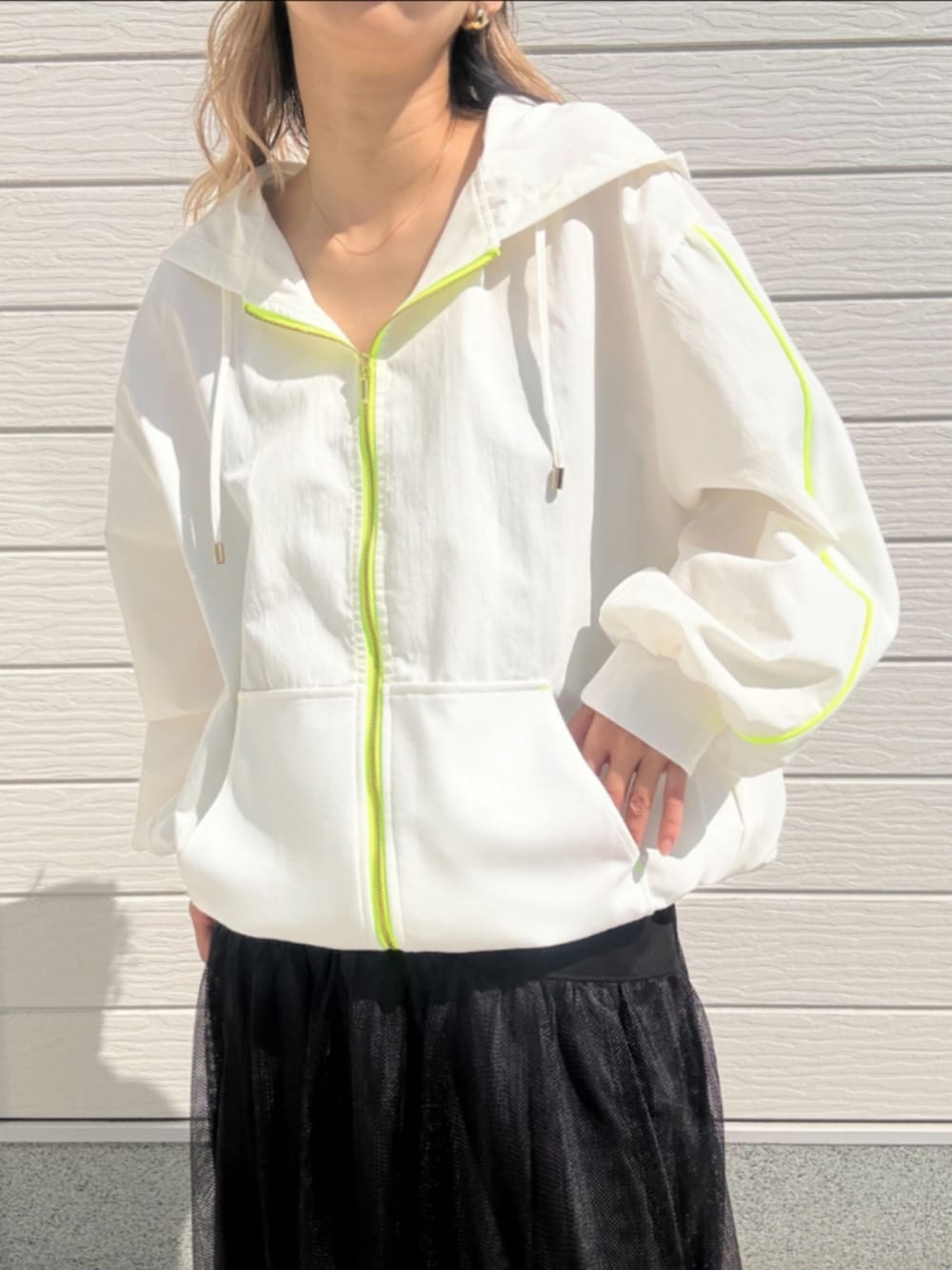 ブラック系のスカート、ブラック系のパーカーを着用したレディースの春コーディネートの4枚目の写真