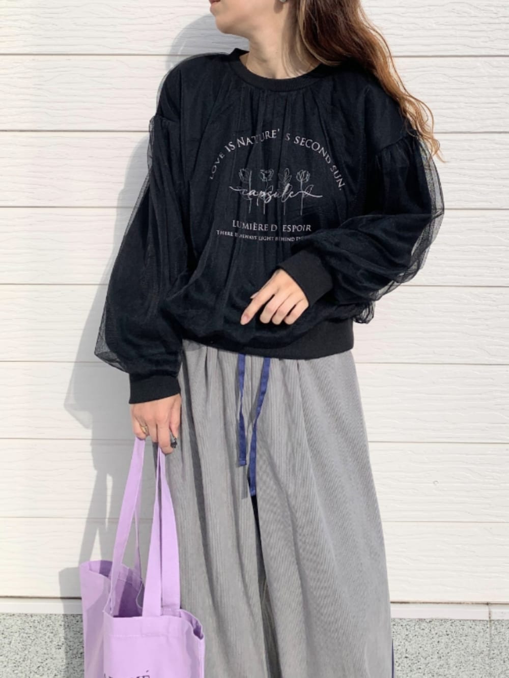 パープル系のトートバッグ、ホワイト系のスニーカー、グレー系のその他パンツを着用したレディースの秋コーディネートの4枚目の写真