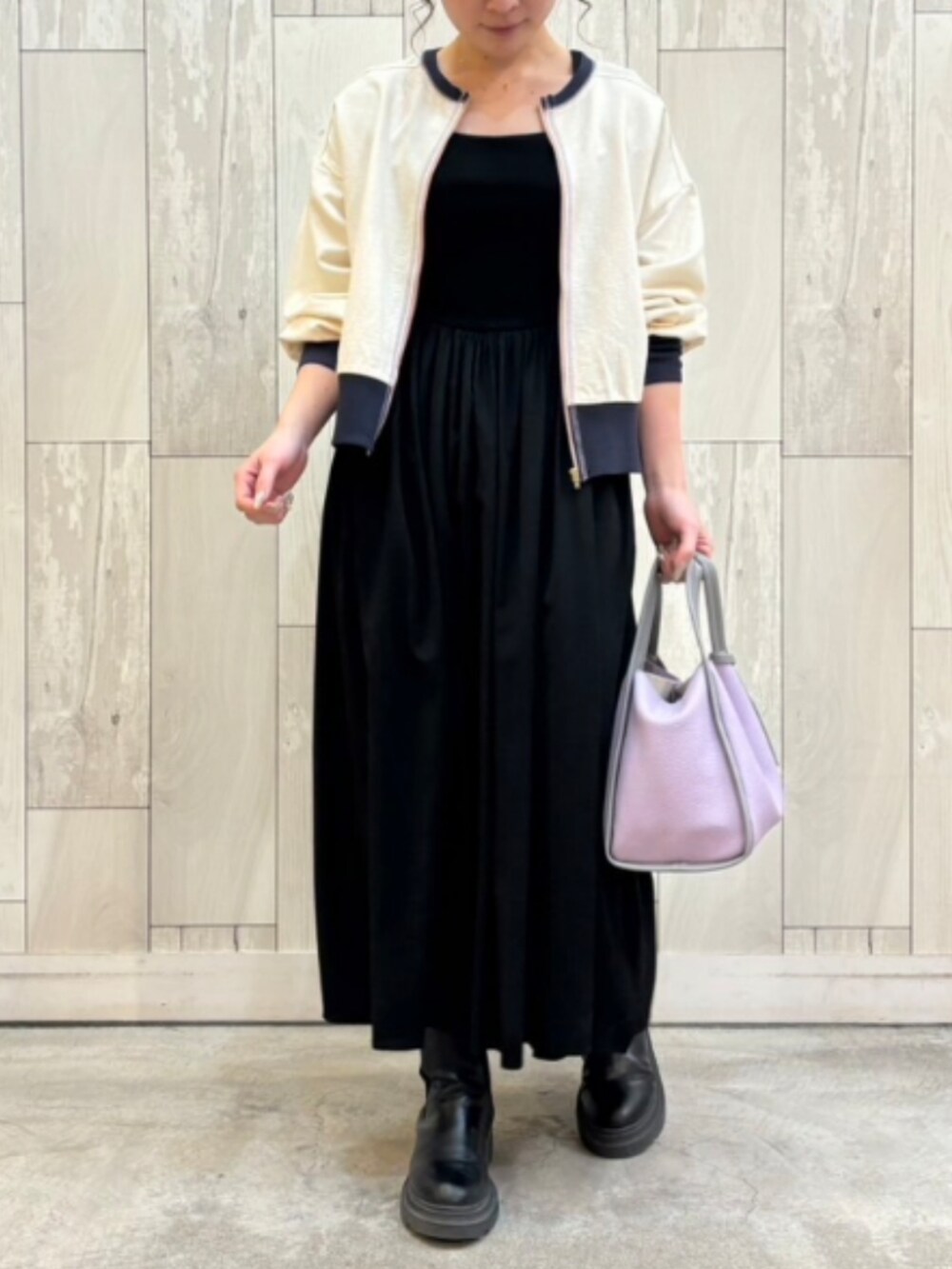 パープル系のトートバッグ、ホワイト系のカーディガン/ボレロを着用したレディースの冬コーディネートの2枚目の写真