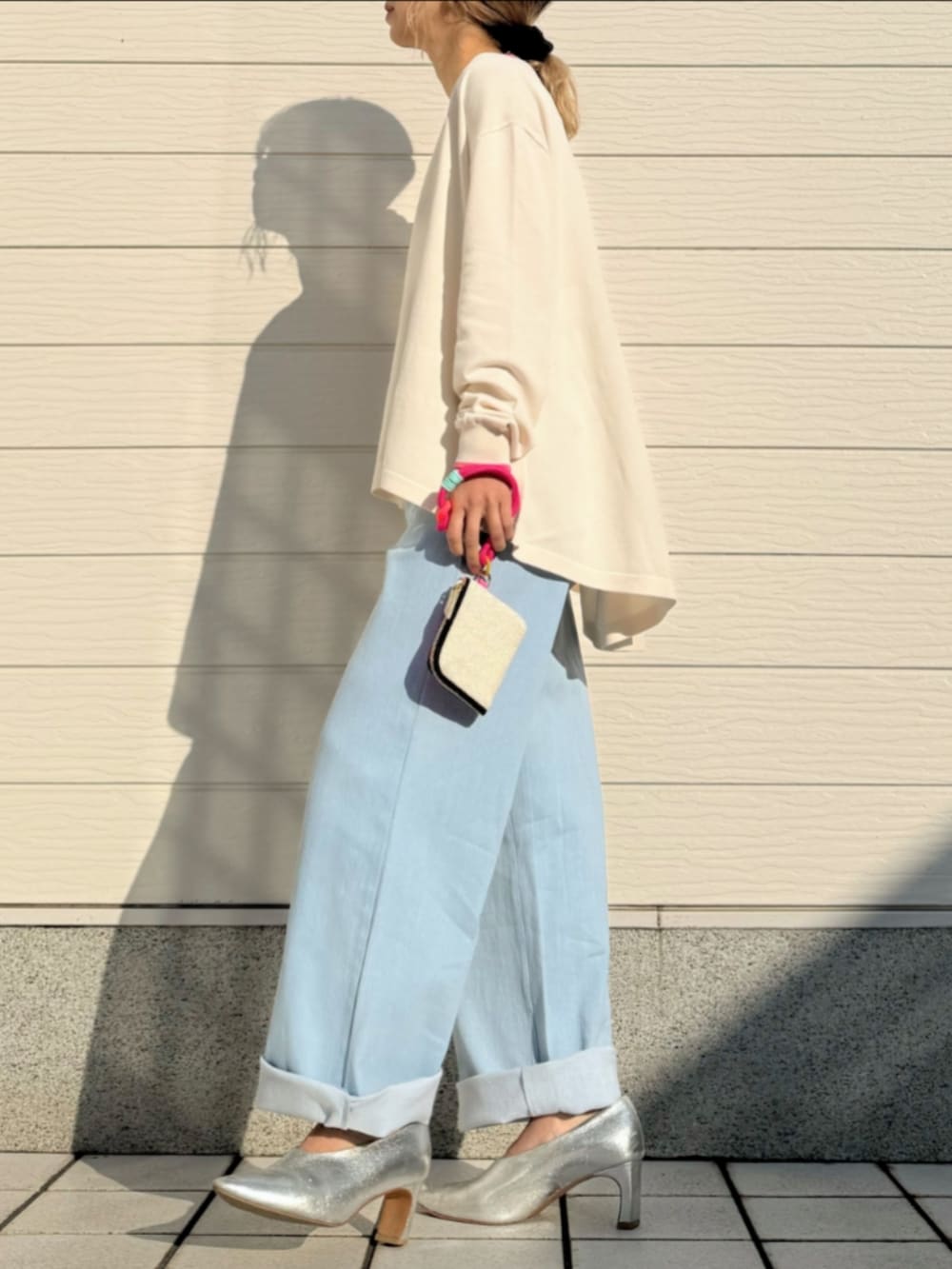 ブルー系のデニムパンツ、グレー系のタンクトップ、ベージュ系のカーディガン/ボレロを着用したレディースの冬コーディネートの2枚目の写真