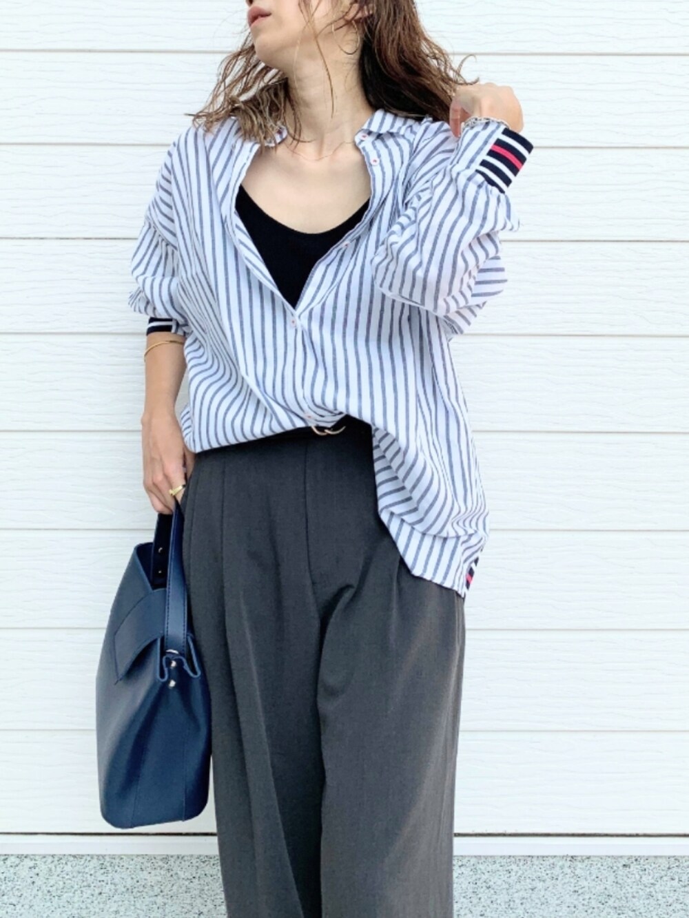 ブルー系のハンドバッグ、ブルー系のシャツ/ブラウス、ブラック系のキャミソールを着用したレディースの夏コーディネートの5枚目の写真