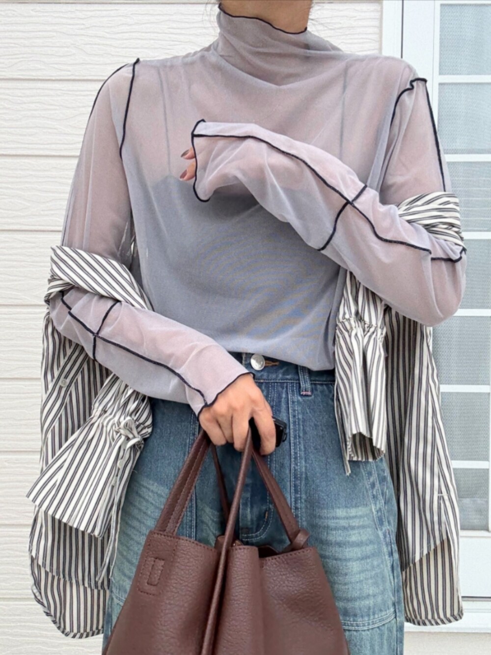 ブラウン系のハンドバッグ、ブラック系のシャツ/ブラウス、グレー系のTシャツ/カットソーを着用したレディースの秋コーディネートの5枚目の写真