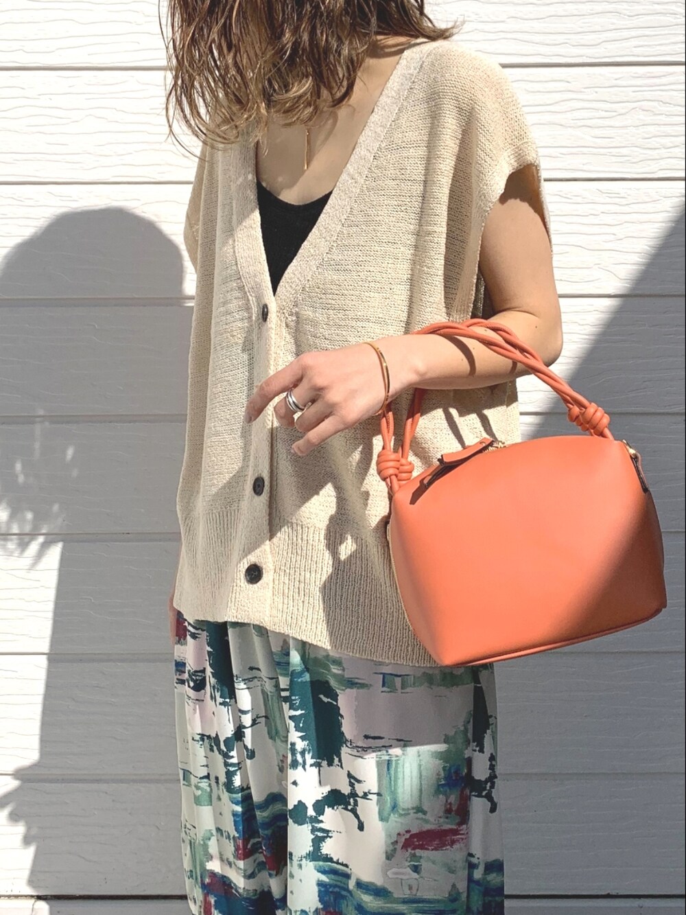 グリーン系のその他パンツ、イエロー系のサンダル、ホワイト系のベストを着用したレディースの春コーディネートの4枚目の写真