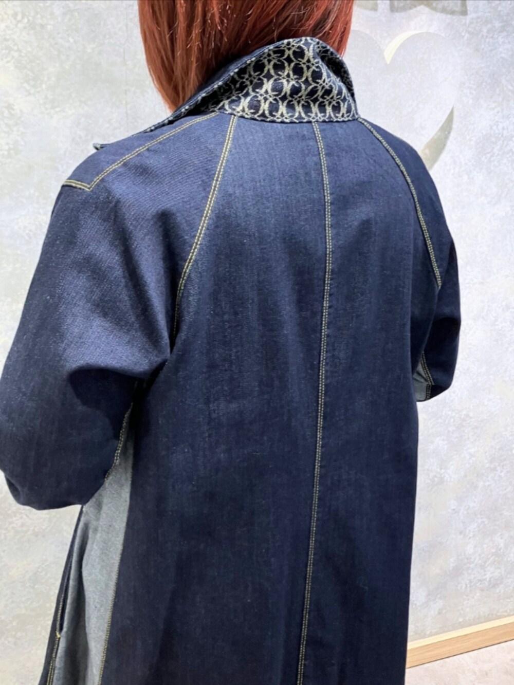 グレー系のブーツ、ブルー系のデニムジャケット、ブラック系のスカートを着用したレディースの秋コーディネートの4枚目の写真