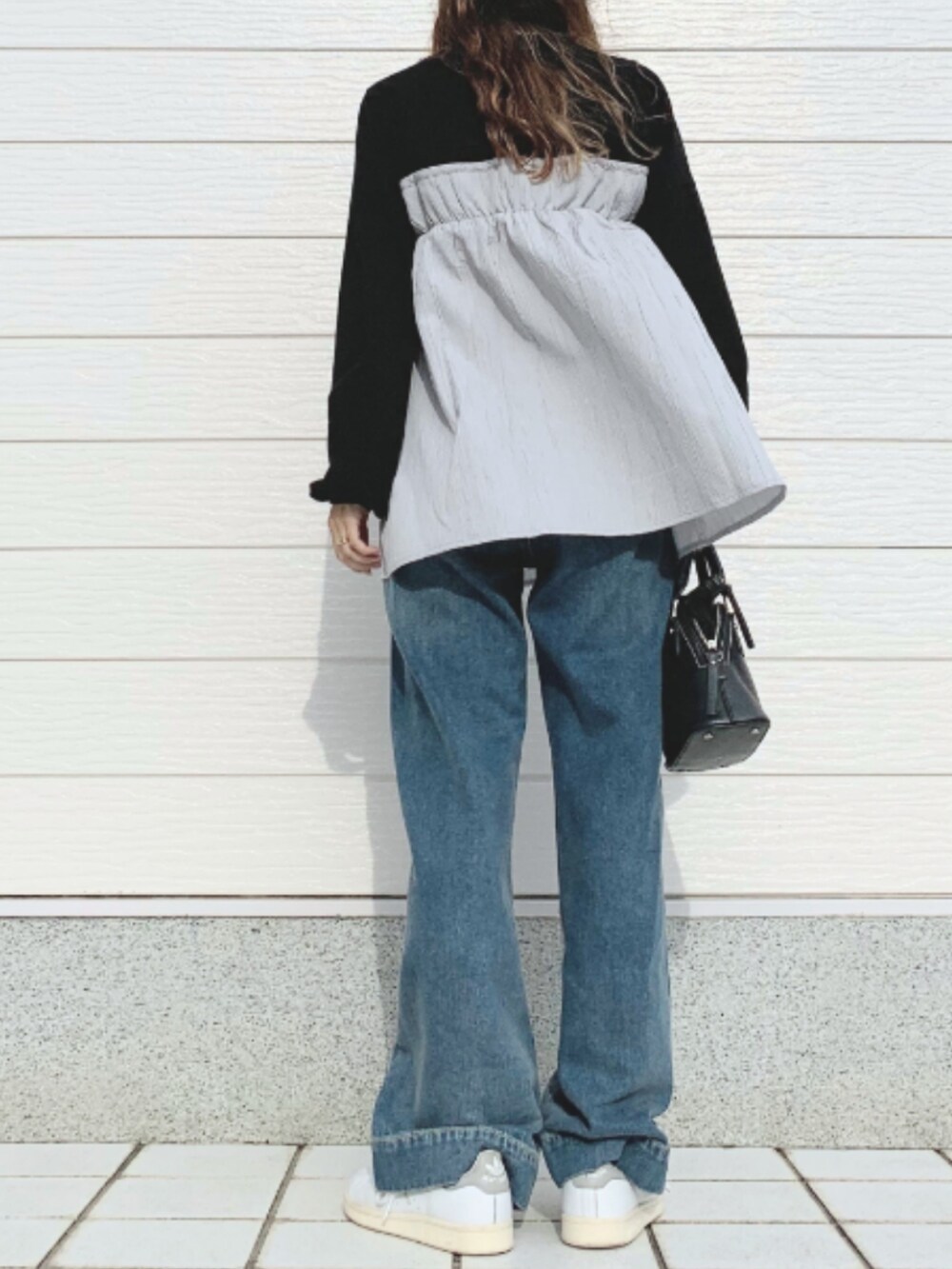 ブルー系のデニムパンツ、ホワイト系のスニーカー、ブラック系のTシャツ/カットソーを着用したレディースの夏コーディネートの3枚目の写真