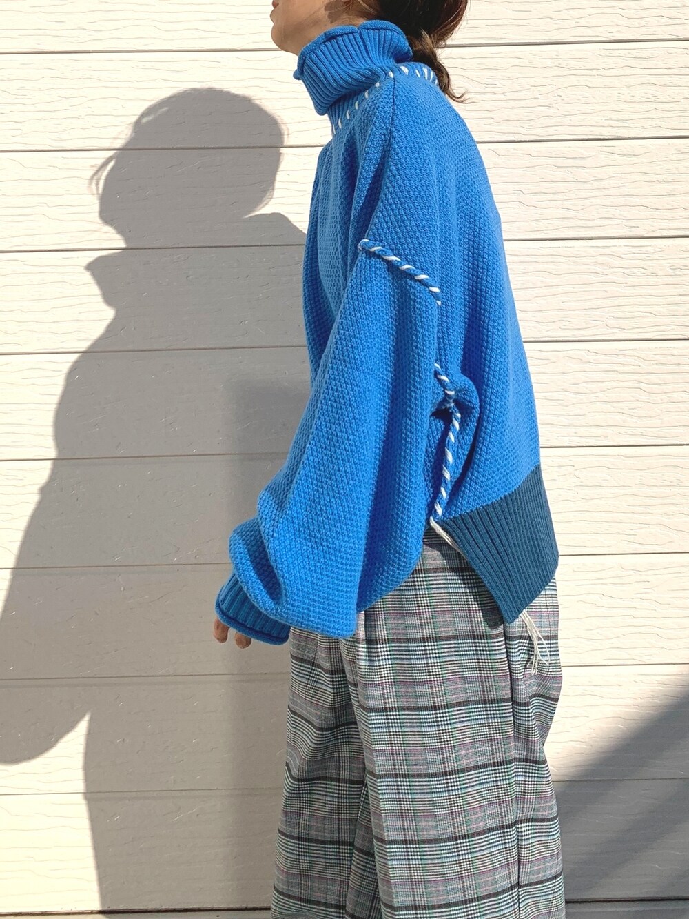 ブルー系のニット/セーター、シルバー系のショルダーバッグ、ブラウン系のその他パンツを着用したレディースの秋コーディネートの4枚目の写真