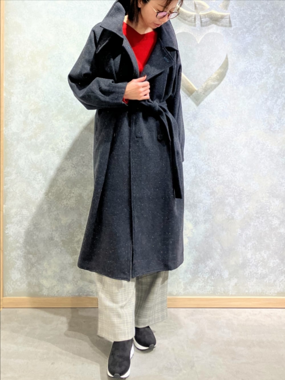 グレー系のブーツ、ベージュ系のスラックス、グレー系のその他アウターを着用したレディースの冬コーディネートの2枚目の写真