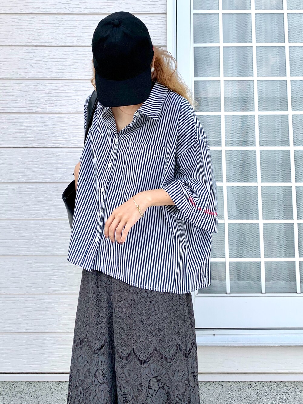 ブルー系のシャツ/ブラウス、ブラック系のトートバッグ、グレー系のその他パンツを着用したレディースの夏コーディネートの4枚目の写真