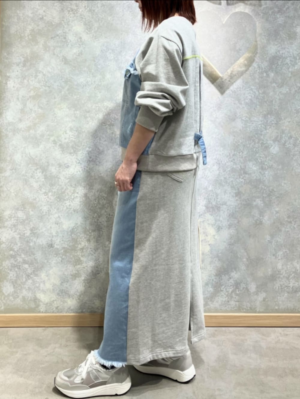 ブルー系のスカート、ブルー系のスウェット、シルバー系のスニーカーを着用したレディースの冬コーディネートの2枚目の写真