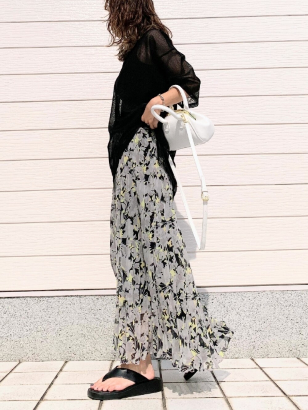 ブラック系のスカート、ホワイト系のショルダーバッグ、ブラック系のTシャツ/カットソーを着用したレディースの夏コーディネートの3枚目の写真