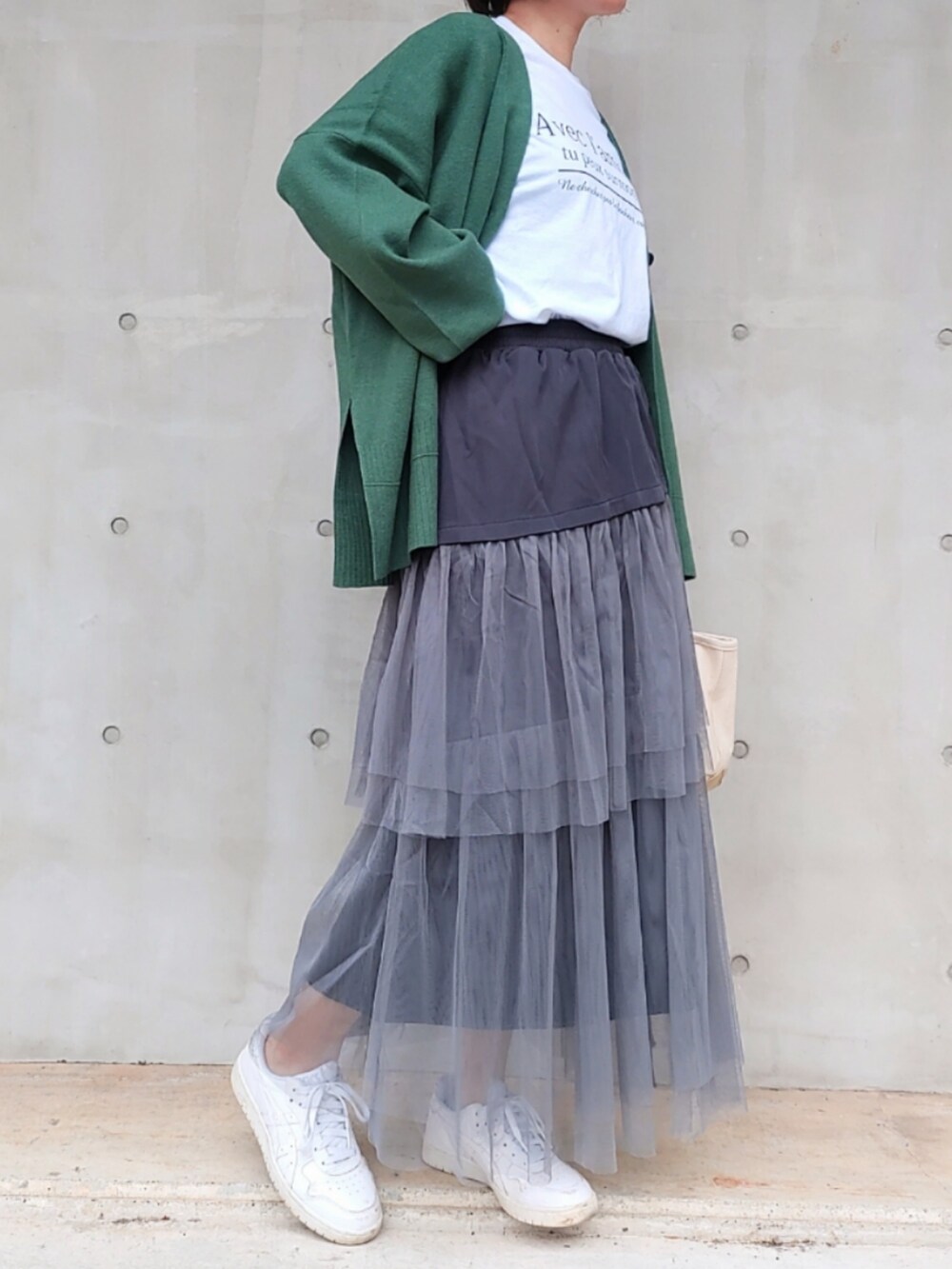 ホワイト系のTシャツ/カットソー、グリーン系のカーディガン/ボレロ、ベージュ系のトートバッグを着用したレディースの秋コーディネートの3枚目の写真