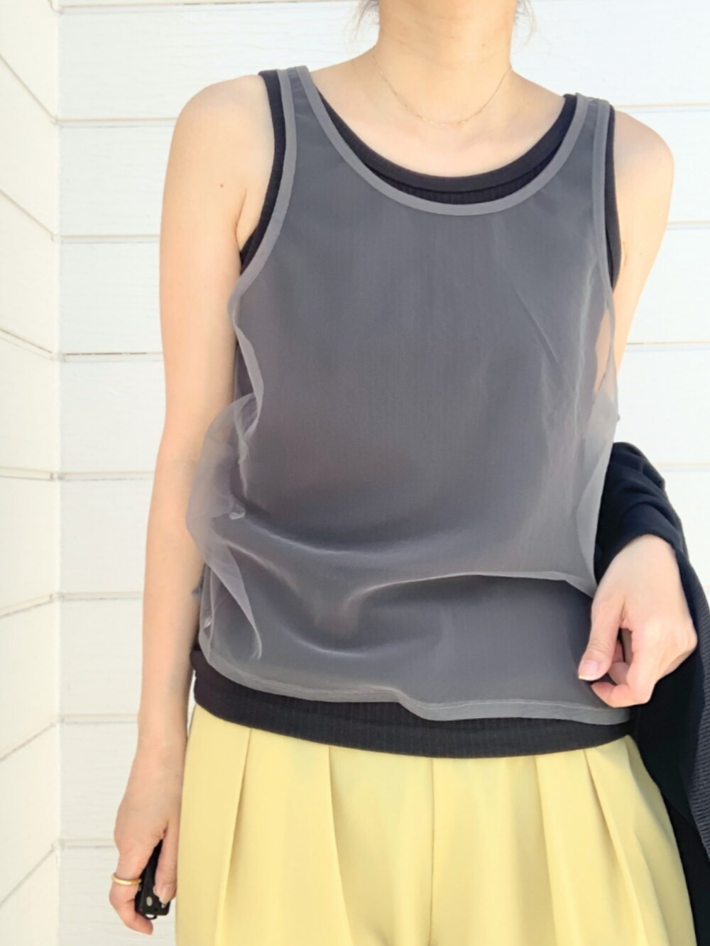 イエロー系のその他パンツ、ブラック系のタンクトップ、ブラック系のカーディガン/ボレロを着用したレディースの春コーディネートの4枚目の写真