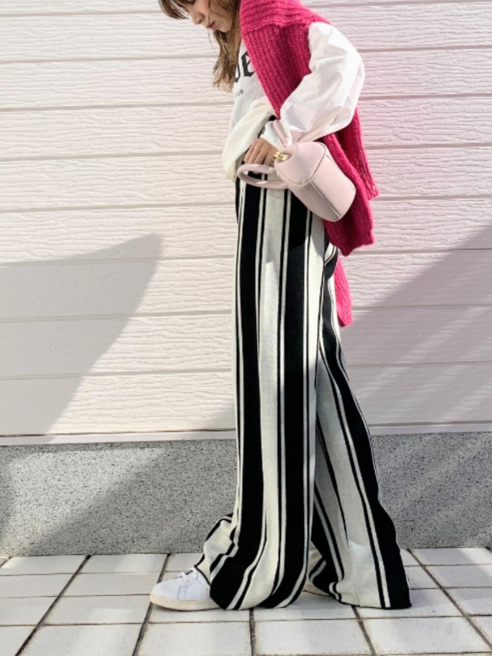 ホワイト系のTシャツ/カットソー、ピンク系のショルダーバッグ、ピンク系のニット/セーターを着用したレディースの冬コーディネートの3枚目の写真