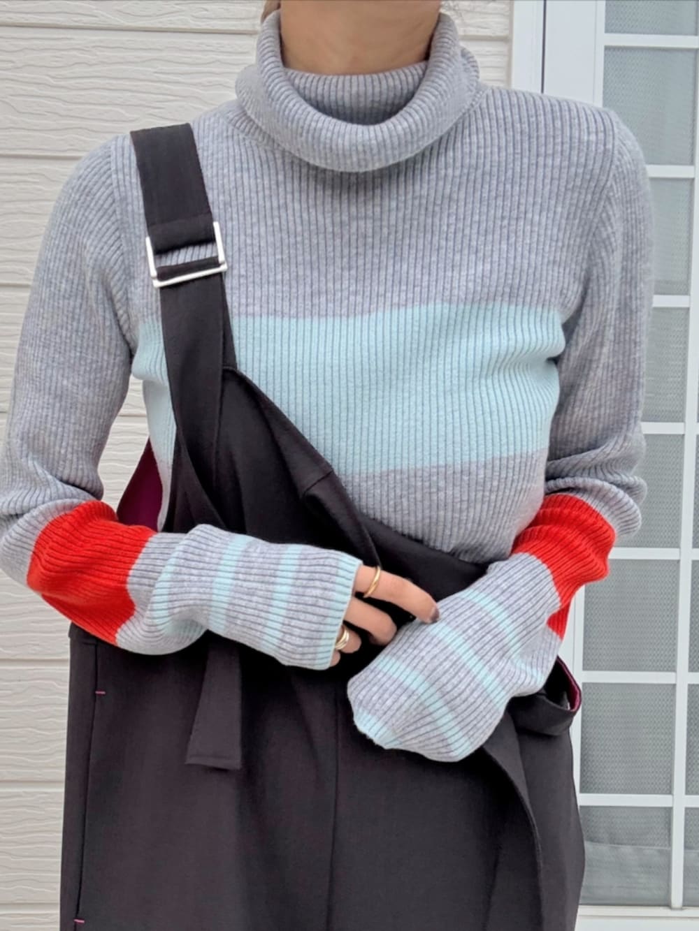 ブラック系のバックパック/リュック、グレー系のサロペット/オーバーオール、グレー系のニット/セーターを着用したレディースの秋コーディネートの4枚目の写真