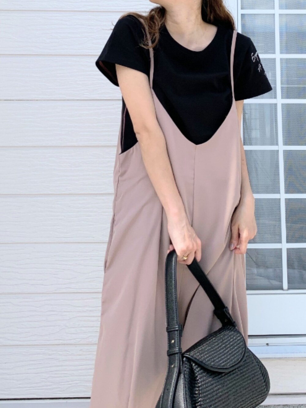 ブラウン系のサンダル、ブラック系のTシャツ/カットソー、ベージュ系のサロペット/オーバーオールを着用したレディースの春コーディネートの4枚目の写真