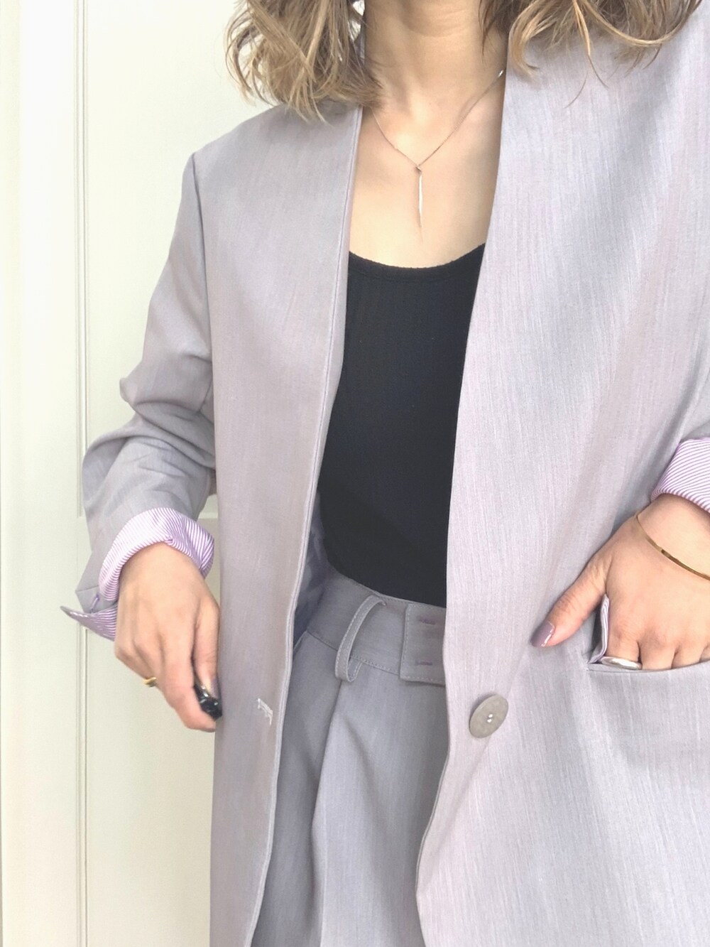 グレー系のその他パンツ、グレー系のノーカラージャケット、ブルー系のハンドバッグを着用したレディースの冬コーディネートの4枚目の写真