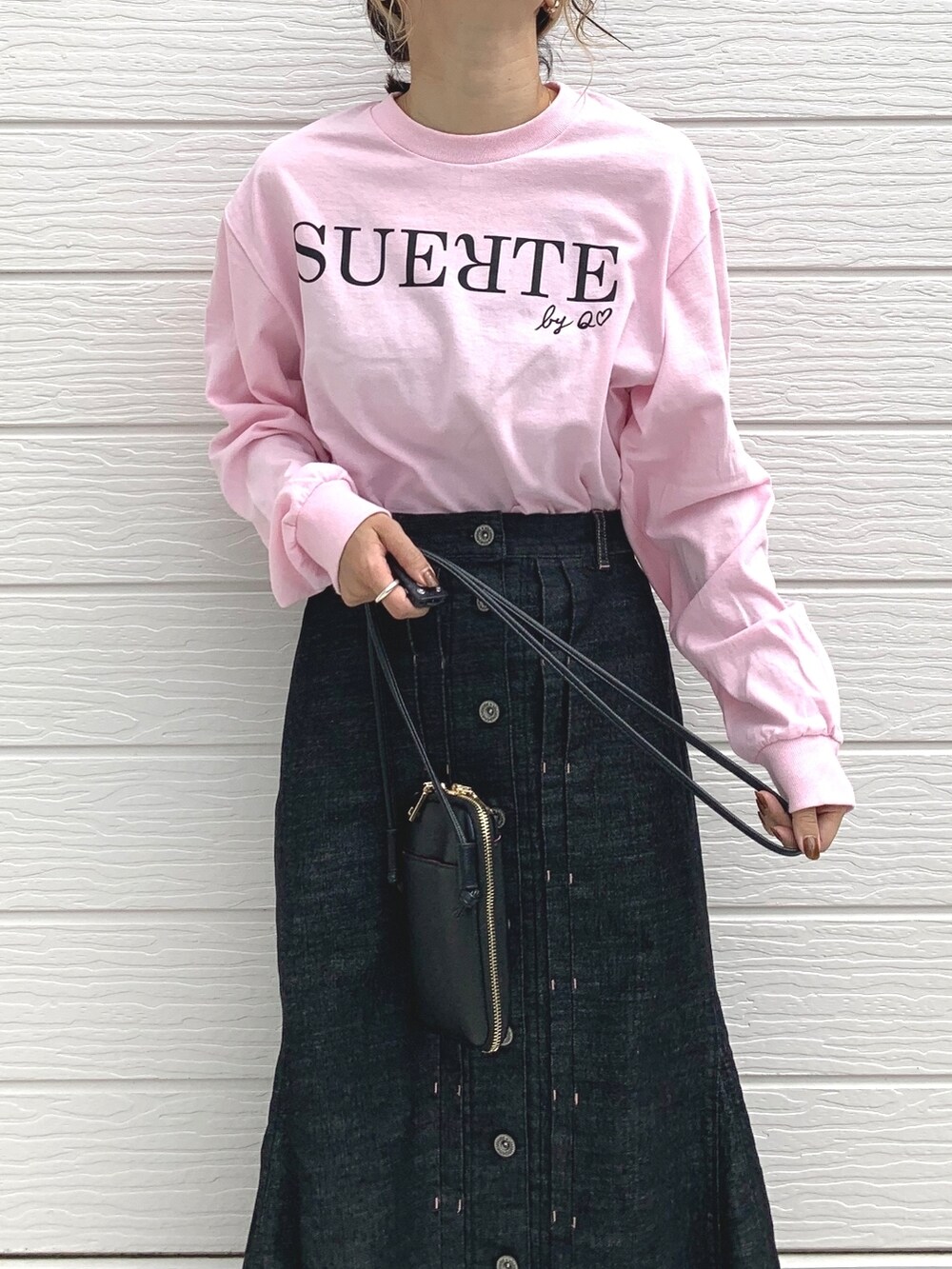 シルバー系のスニーカー、ピンク系のTシャツ/カットソー、ブラック系のショルダーバッグを着用したレディースの秋コーディネートの3枚目の写真