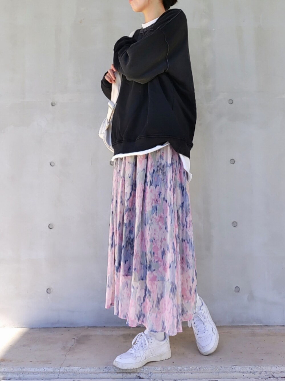 ブルー系のスカート、ホワイト系のスニーカー、ブラック系のスウェットを着用したレディースの冬コーディネートの3枚目の写真