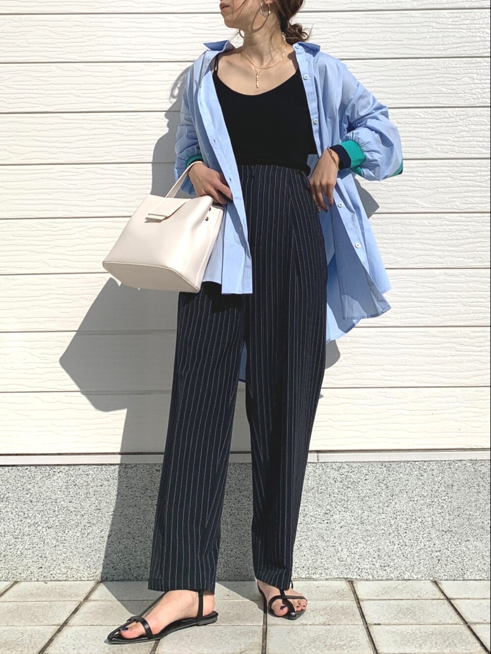 ブルー系のその他パンツ、ホワイト系のハンドバッグ、ブラック系のキャミソールを着用したレディースの春コーディネートの2枚目の写真