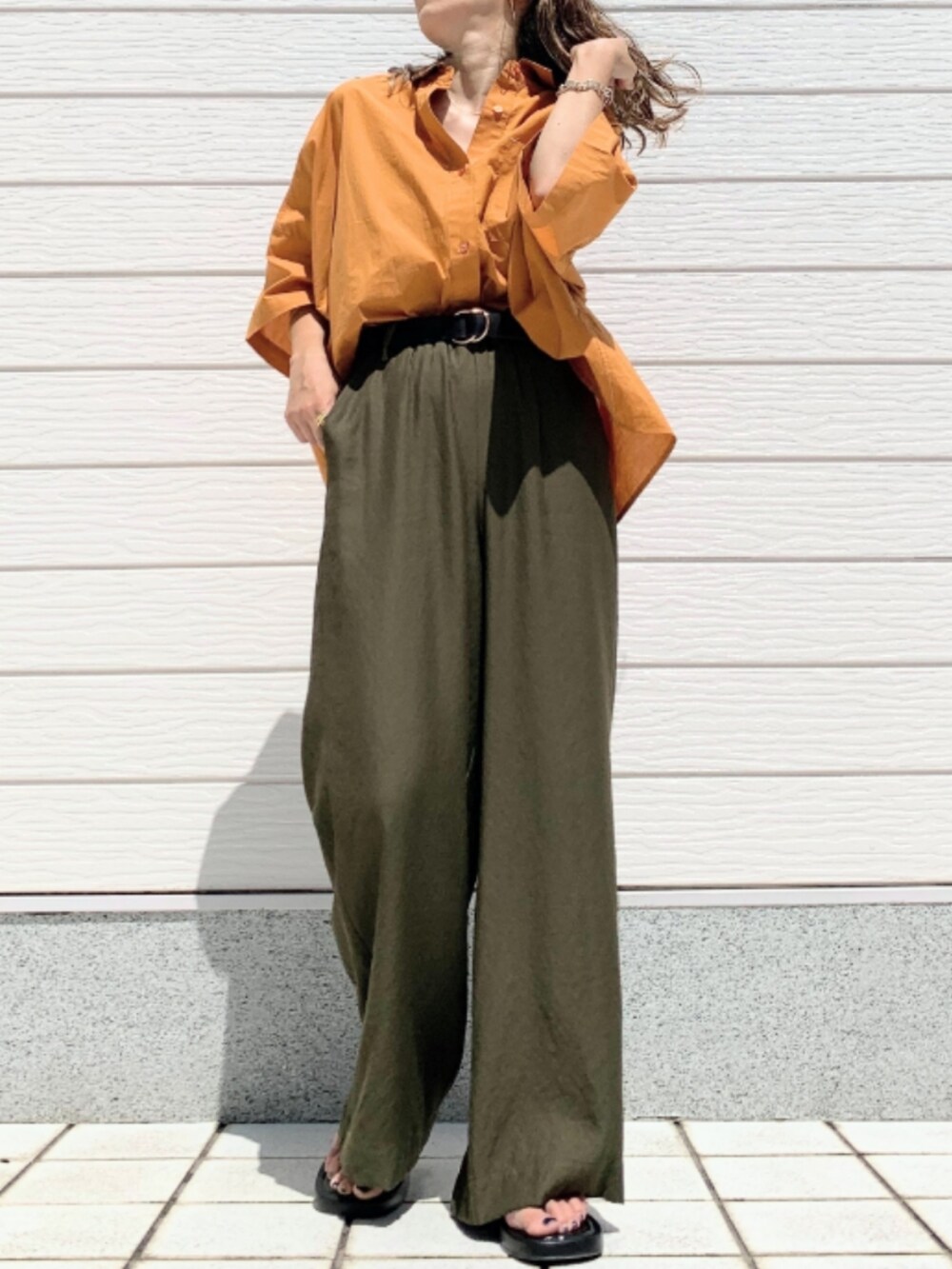 グリーン系のその他パンツ、オレンジ系のシャツ/ブラウスを着用したレディースの夏コーディネートの2枚目の写真