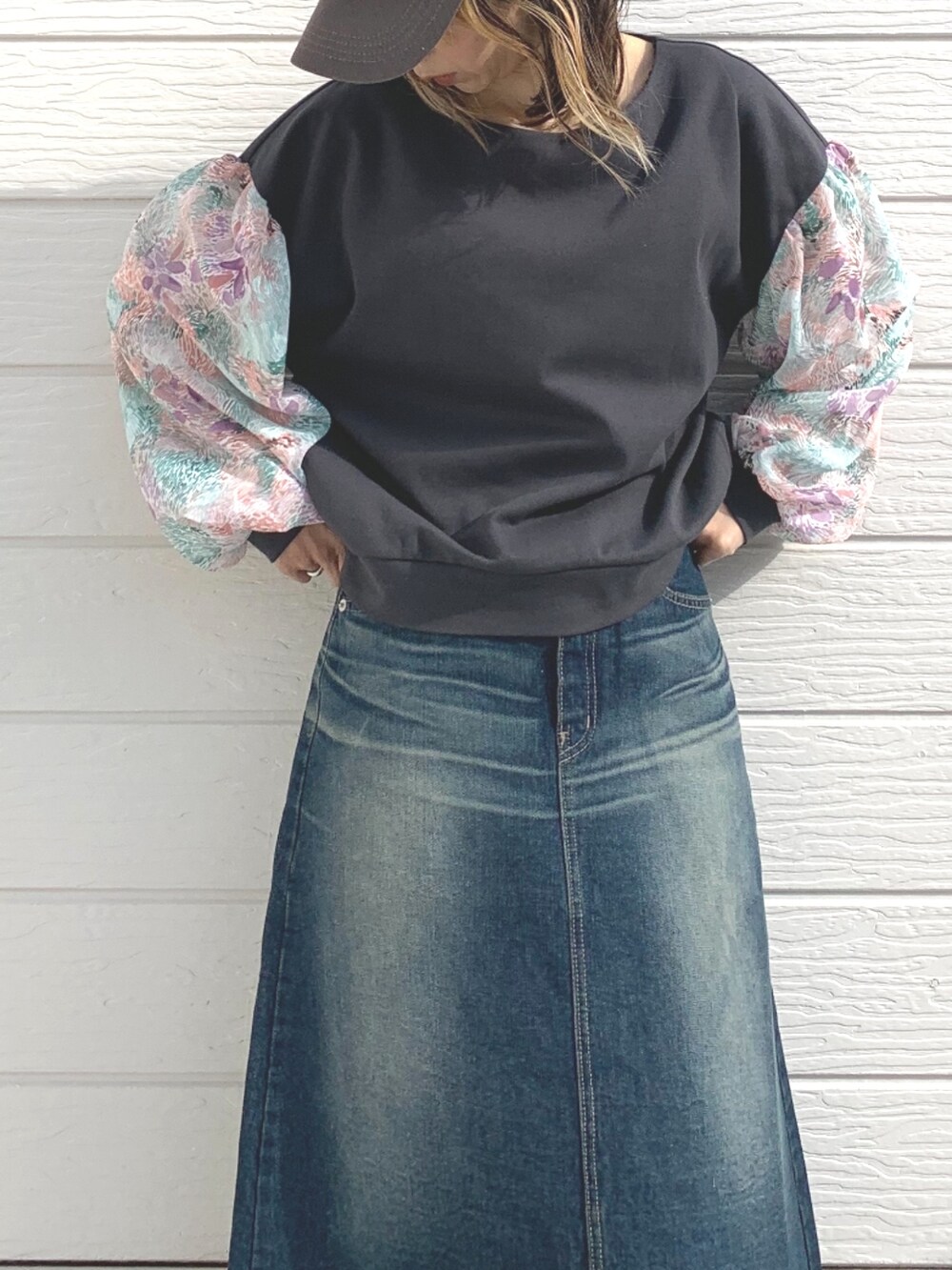 ブルー系のデニムスカート、グレー系のTシャツ/カットソー、ホワイト系のスニーカーを着用したレディースの冬コーディネートの3枚目の写真
