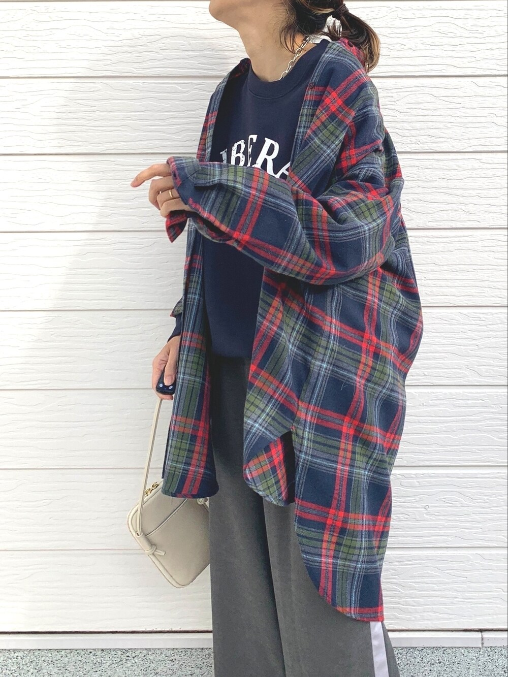 ブルー系のスウェット、グレー系のその他パンツ、ホワイト系のショルダーバッグを着用したレディースの冬コーディネートの4枚目の写真