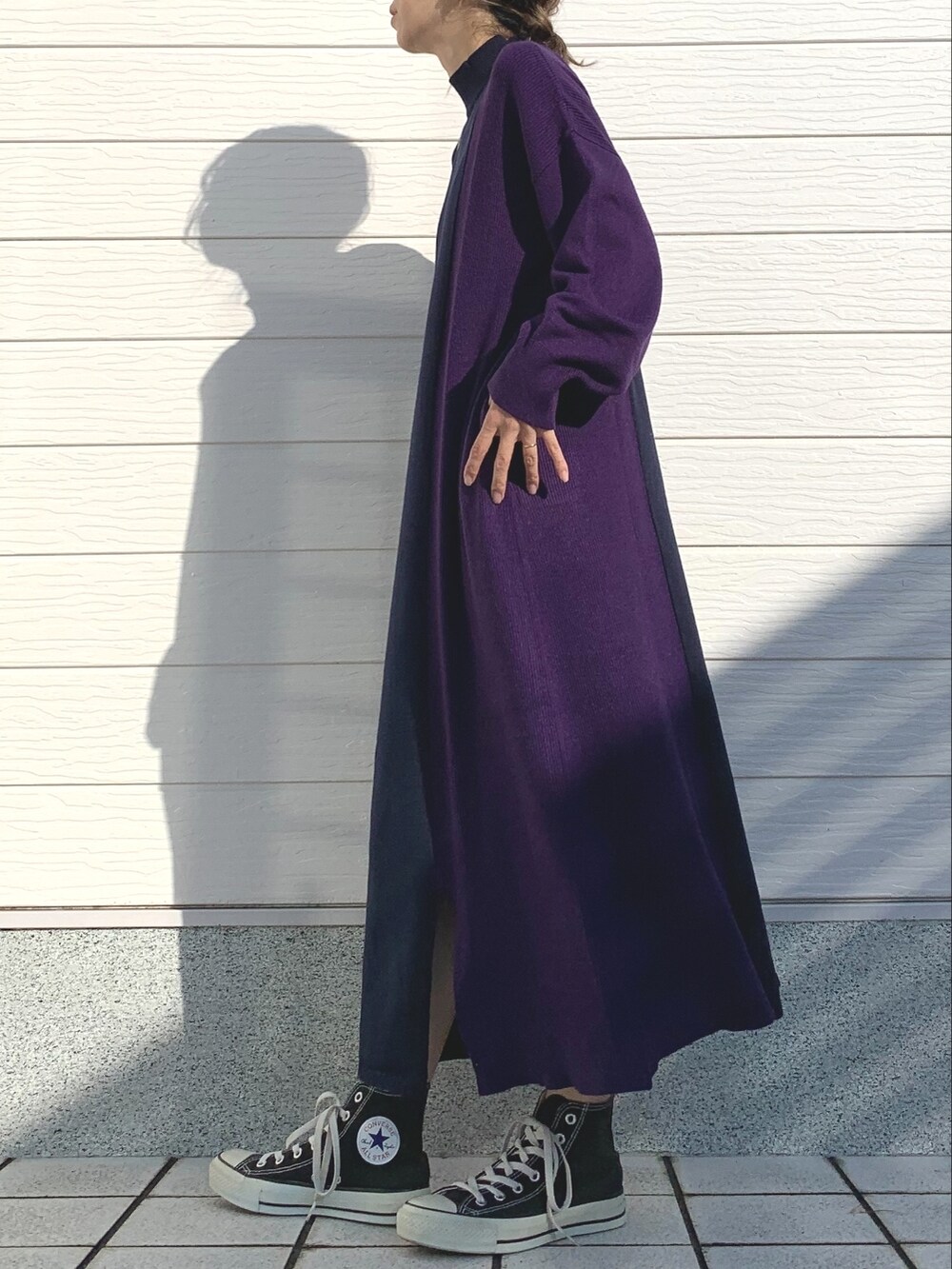 ブルー系のワンピース、ブラック系のスニーカー、ホワイト系のショルダーバッグを着用したレディースの秋コーディネートの2枚目の写真