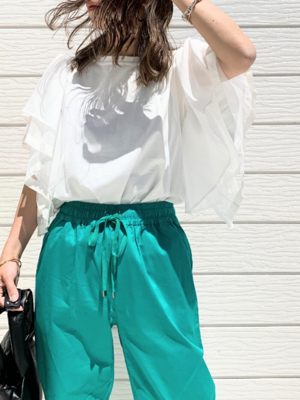 グリーン系のその他パンツ、ホワイト系のTシャツ/カットソーを着用したレディースの春コーディネートの4枚目の写真