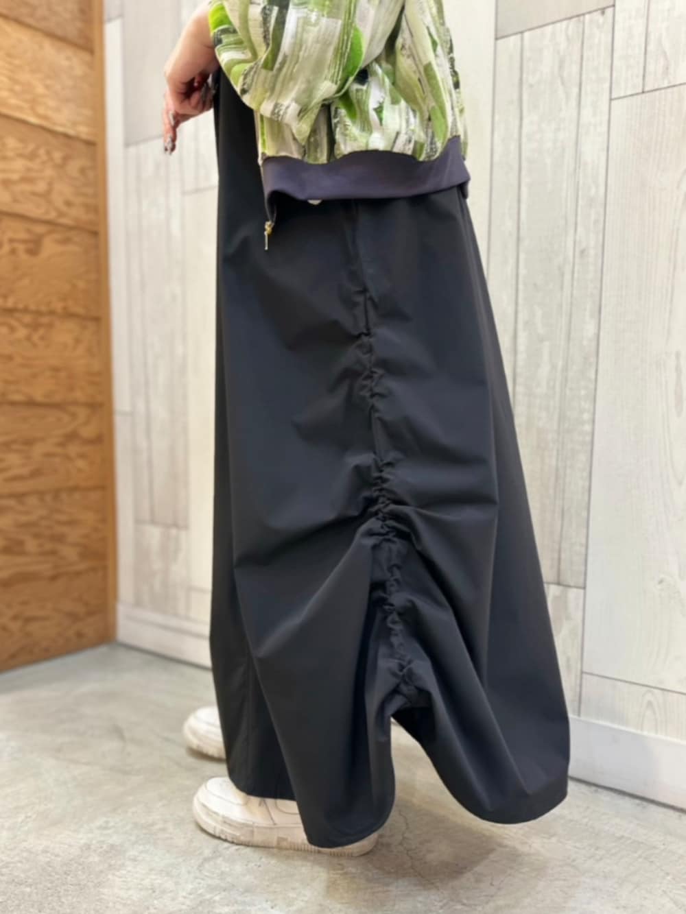 ブラック系のワンピース、グリーン系のブルゾンを着用したレディースの春コーディネートの3枚目の写真