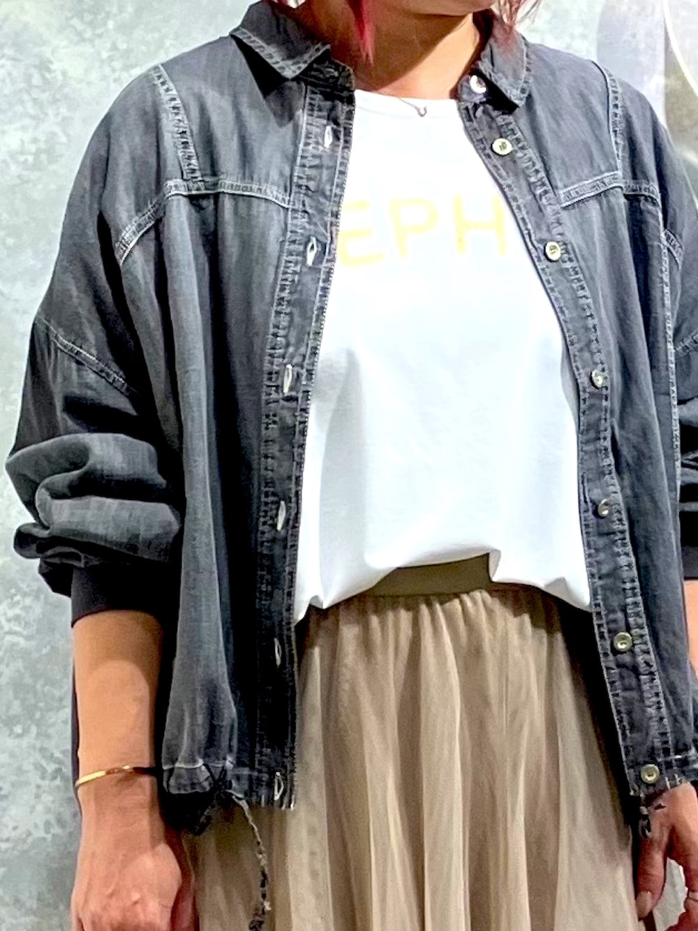 ゴールド系のスカート、ブルー系のシャツ/ブラウス、ホワイト系のTシャツ/カットソーを着用したレディースの夏コーディネートの2枚目の写真