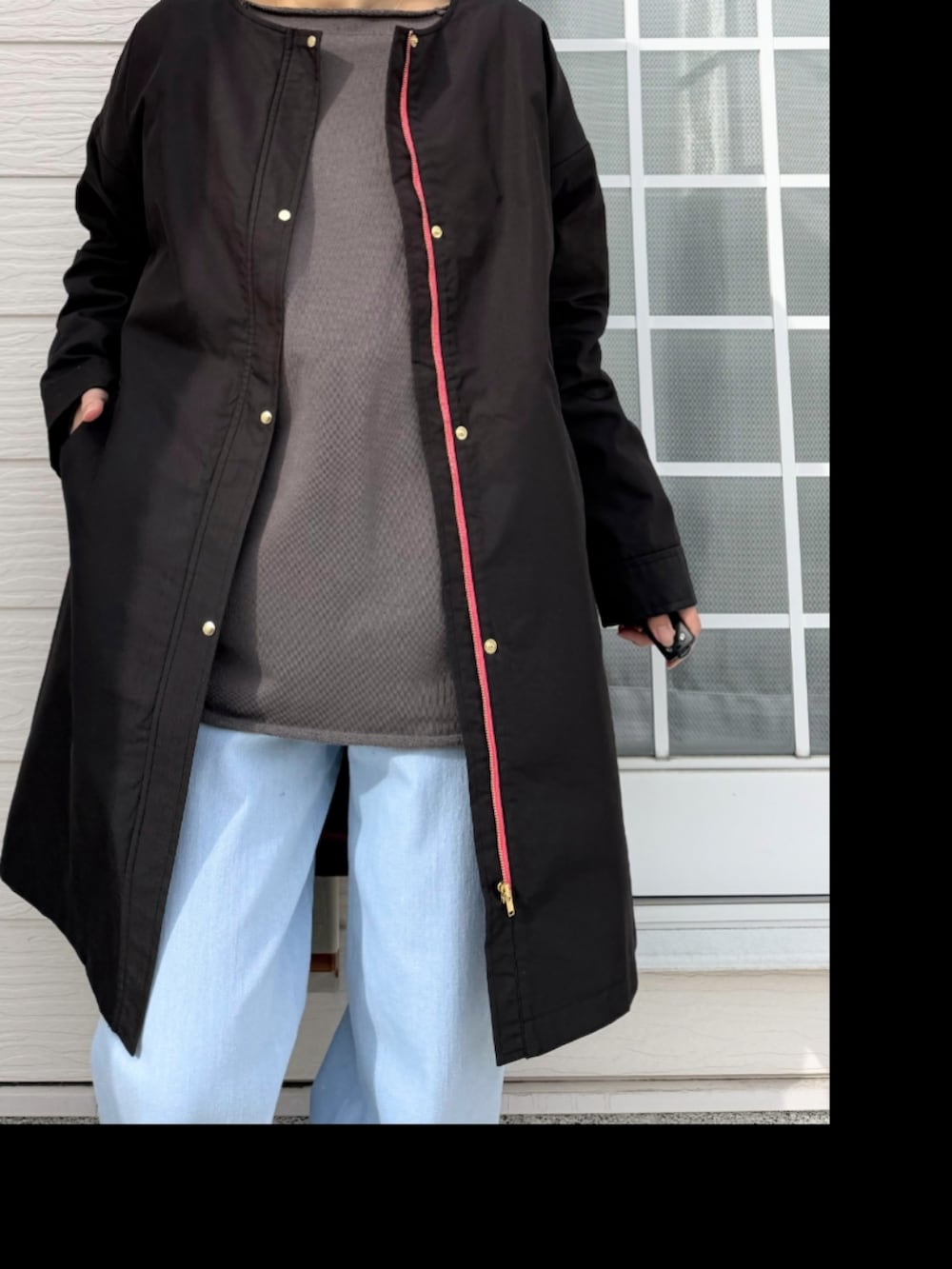 ブルー系のデニムパンツ、ブラック系のサンダル、グレー系のスウェットを着用したレディースの冬コーディネートの4枚目の写真