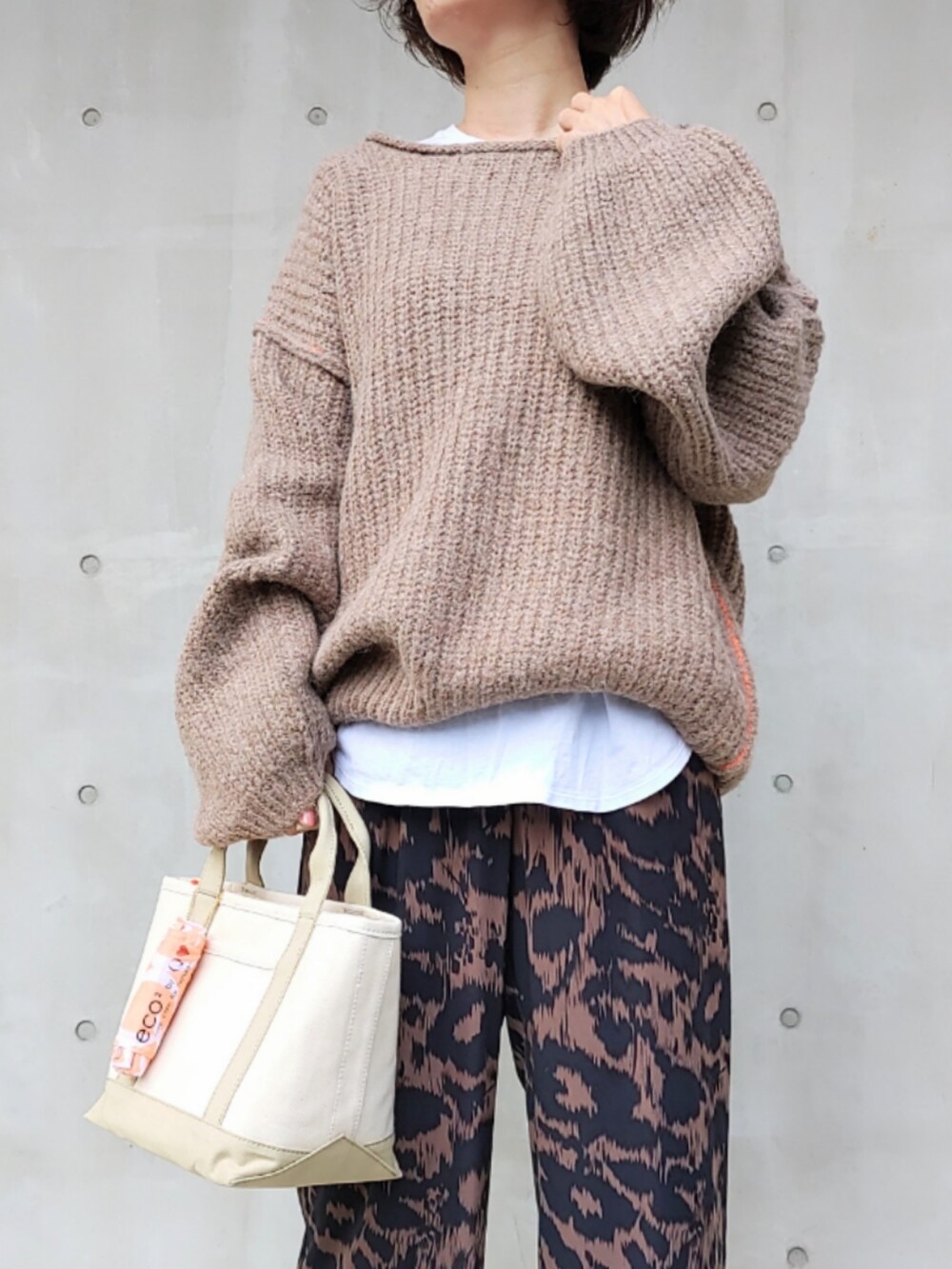 ブラウン系のその他パンツ、ベージュ系のニット/セーター、ベージュ系のトートバッグを着用したレディースの秋コーディネートの3枚目の写真