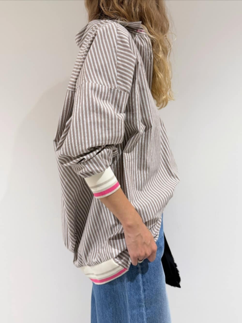 ブラック系のサンダル、ブルー系のデニムパンツ、ベージュ系のシャツ/ブラウスを着用したレディースの秋コーディネートの4枚目の写真